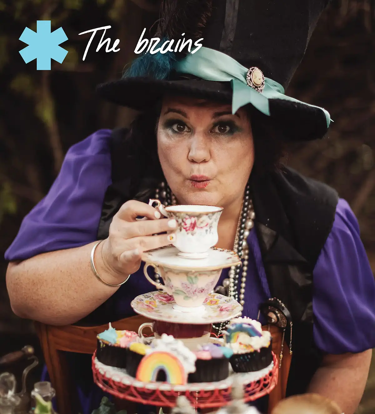 Pauline Stockhausen, sipping a cup of tea with a high tea in a quirky, fun photoshoot setting